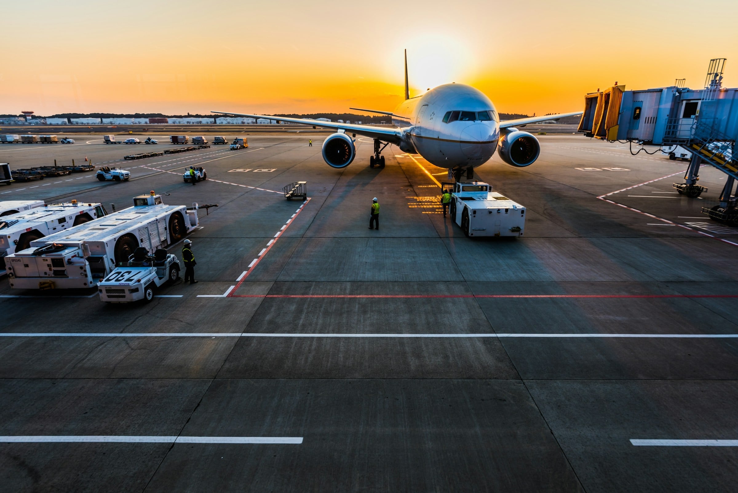 Wide-body cargo aircraft on the apron at sunset